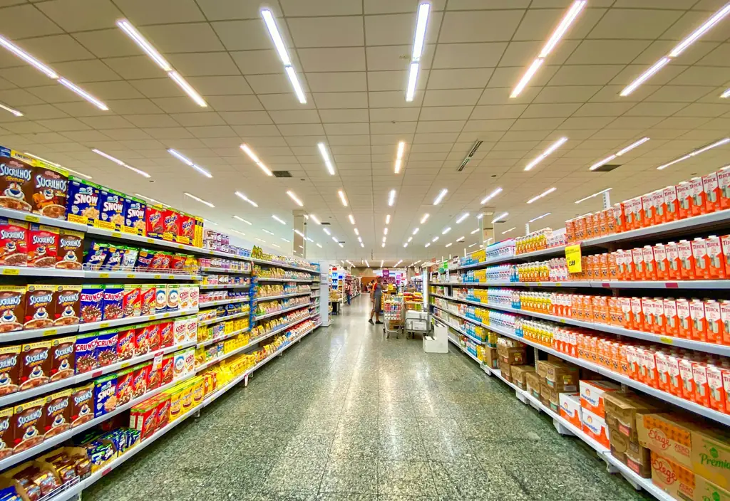 Pasillo de un supermercado con productos en los lineales